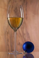 Glass of white wine and Christmas decoration