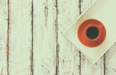 top view image of red cup of tea on a white wooden tray old table.
