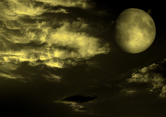 The moon in the night sky in clouds