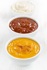 assortment various sauces in bowls, vertical