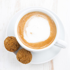 cup of cappuccino and flavored cookies, closeup, top view