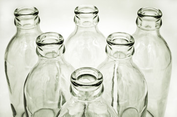 Close up detail of glass bottles on white background. Soft and selective focus