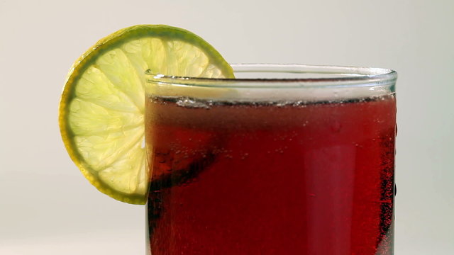 Red Carbonated Drink In Glass With Lemon
