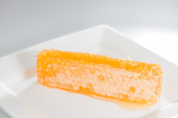 Honeycomb close up on the white plate (shallow DOF)
