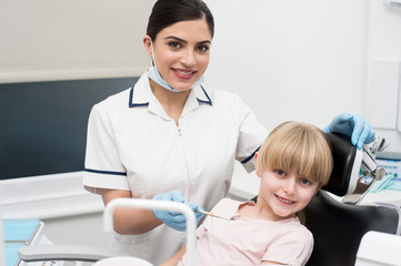 Fototapeta premium Cute girl child at dental clinic