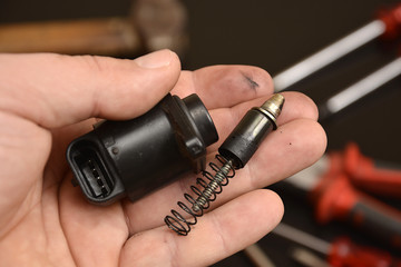 car mechanic shows a stepper motor