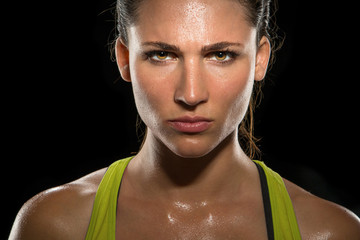 Intense stare eyes determined athlete champion glare head shot sweaty confident woman female powerful fighter close up - Powered by Adobe