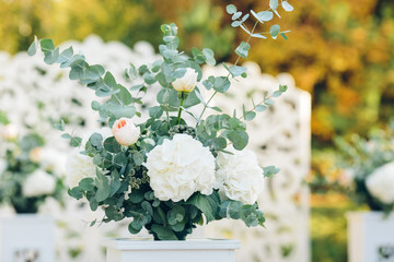 White flowers decorations during outdoor wedding ceremony