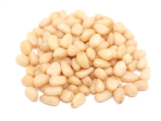 Peeled pine nuts on a white background