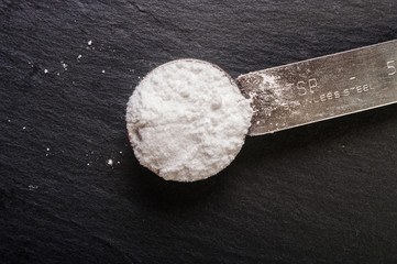 powdered sugar in a metal spoon