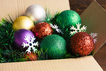 Christmas decoration in a cardboard box on a wooden background c