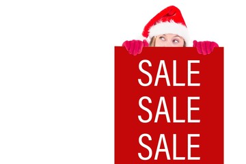 Composite image of festive blonde holding a poster