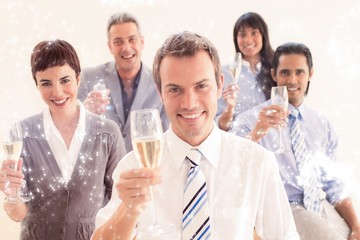 Composite image of business people toasting with champagne