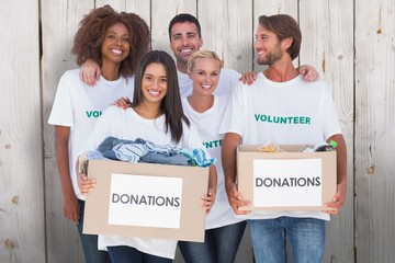 Volunteers holding clothes donation boxes