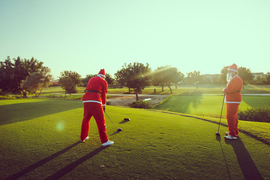 Two Santa Claus on a golf course 