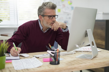 Pensive man working hard on computer