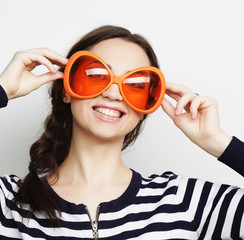 young woman with big orange sunglasses 