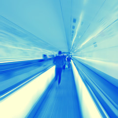 Moving walkway and blurred people.