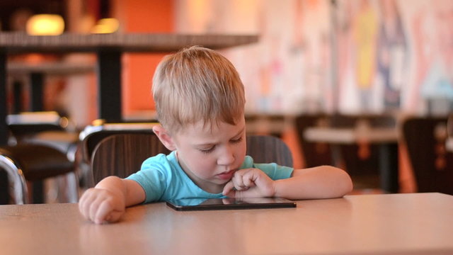 The boy with the tablet in cafe. 60fps
