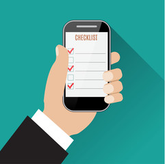 Hand holding smartphone with checklist