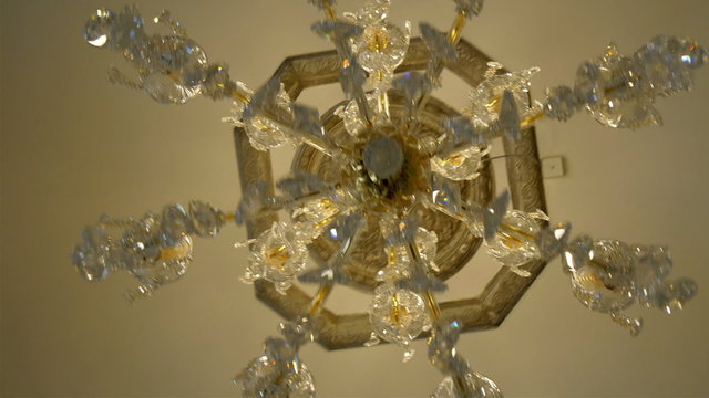 Another piece of chandelier with stones. White crystal stones hanging on the ceiling of the white house