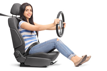 Woman pretending to drive seated on a car seat
