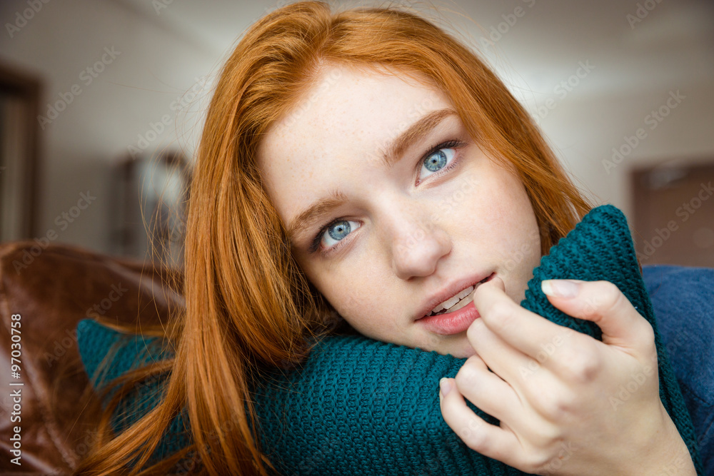 Canvas Prints Thoughtful redhead lady hugging knitted pillow