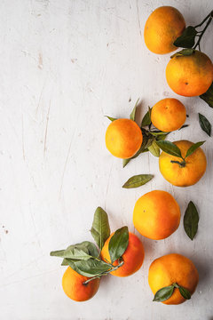 Mandarins at the right on the white wooden table vertical