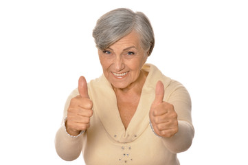 Portrait of elderly woman showing thumbs up 