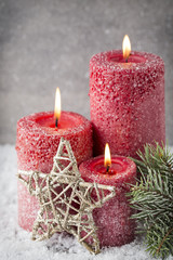 Three red candles on gray background, Christmas decoration. Adve