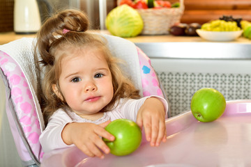 Fototapeta na wymiar Feeding baby. Baby food. Green apple.