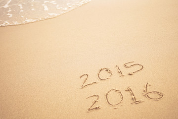 2016 text on the beach for new year concept background
