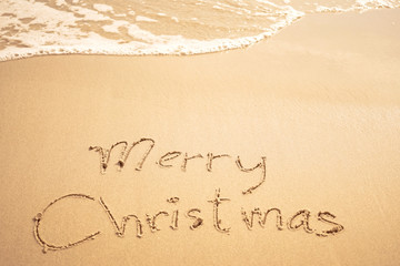 merry christmas written on the beach