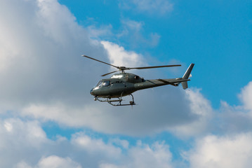 helicopter flying in the blue sky