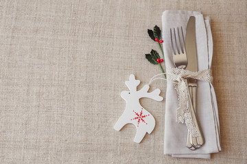 Christmas table place setting, holidays copy space background, selective focus, vintage tone