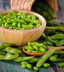 green soy beans in the wood bowl on table