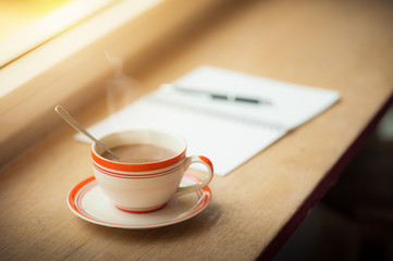 Coffee cup on wood bar in cafe