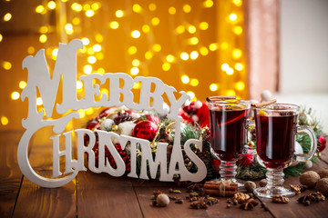 Christmas hot mulled wine with spices on a wooden table. The idea for creating greeting 