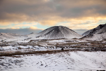 Snowy Icelandic mountains with dramatic cloudy sky