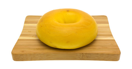 Large egg bagel on a small cutting board