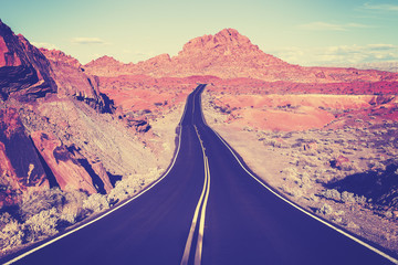 Vintage toned curved desert highway, travel concept, USA