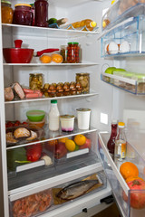 Domestic refrigerator full of a variety of foods
