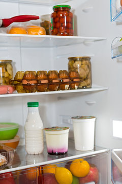 Domestic refrigerator full of a variety of foods