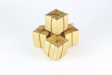Gift box wrap gold paper with gold ribbon and isolated background 