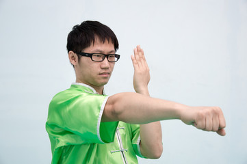 Fototapeta premium Man in green practice martial art in Chinese Martial Arts school.Kung fu