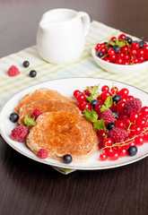 sweet cheese pancakes with fresh berries and milk