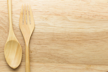 Wooden spoon and fork on wood background