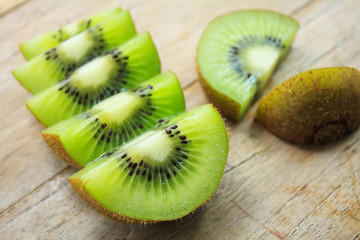 Fresh kiwi fruit on wooden background
