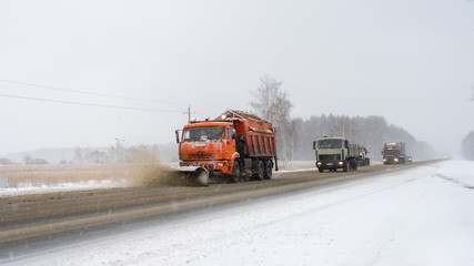 Snowplow removing snow from city road