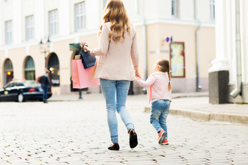 close up of mother and child shopping in city